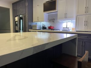 Open Kitchen Layout with Island, White Quartz Countertops in HIghland Vilalge