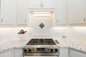 Quartz countertop and commercial gas stove in grapevine kitchen remodel in heritage cove and cannon homestead